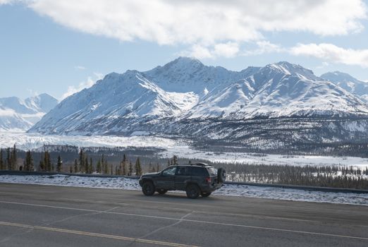 Car on Road with Mountain in Snow behind