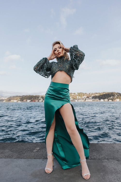 Blonde Woman in Skirt Standing on Shore