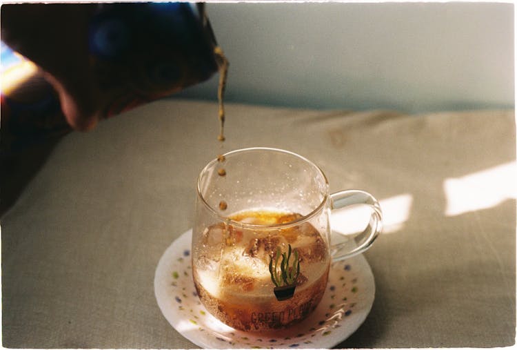 Pouring Black Coffee In Glass Cup