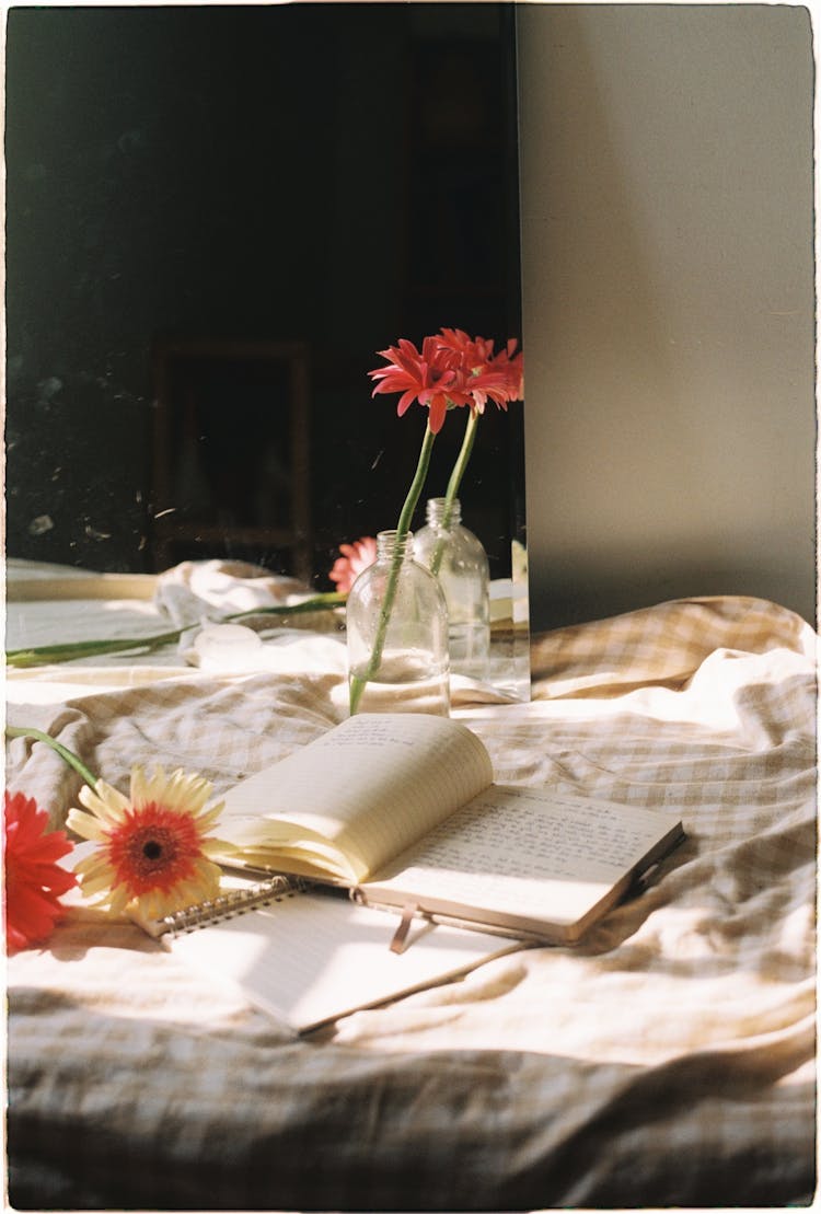 Flowers And Books On A Bed