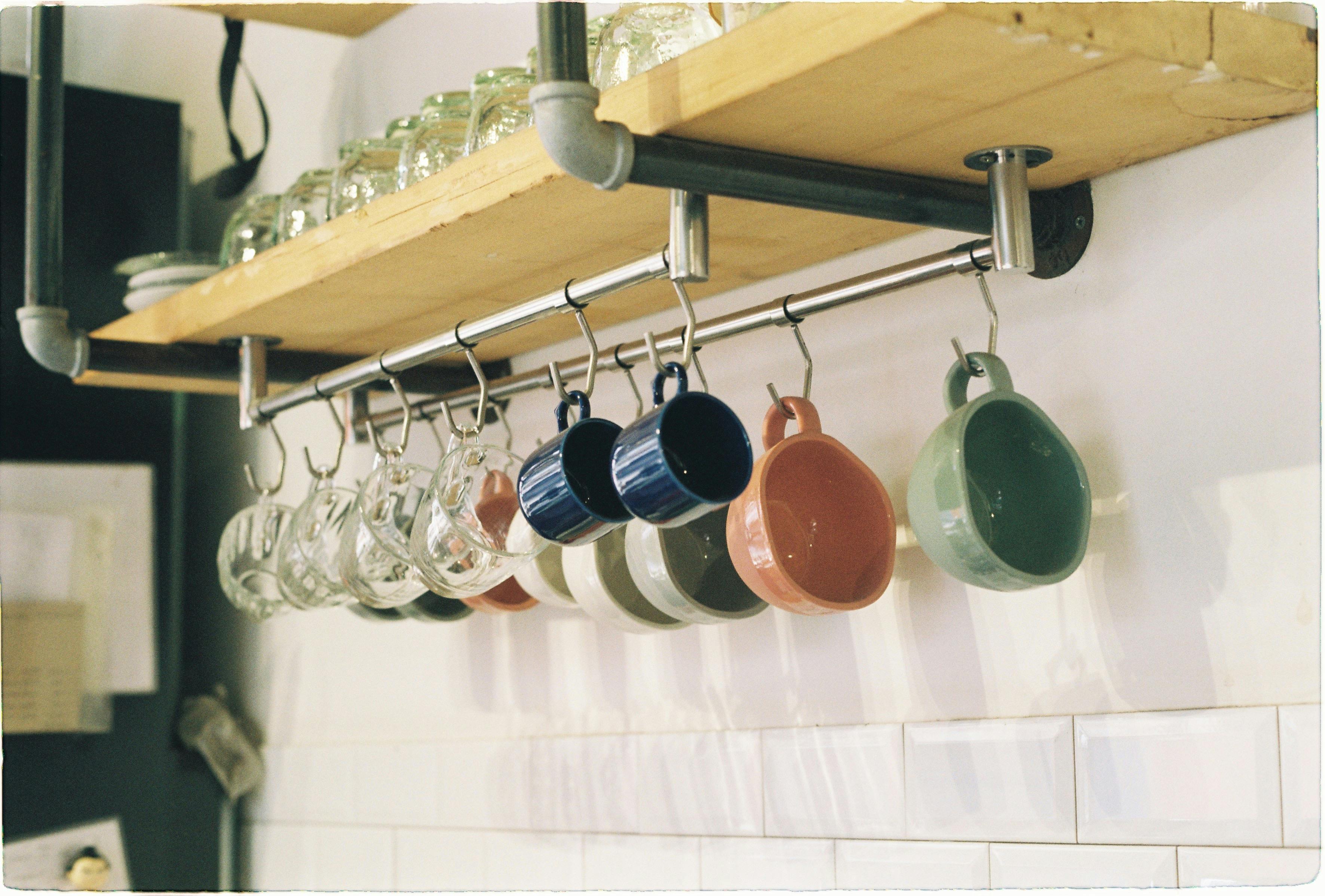 Mugs Hanging on Shelf on Home Kitchen · Free Stock Photo
