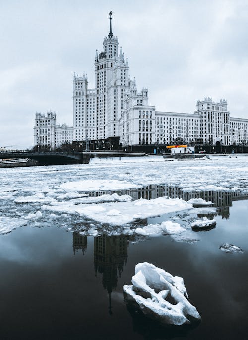 Gray Image of a Palace and Melted Snow on a City Square