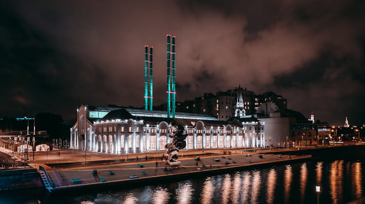 Illuminated Factory Under Clouds At Night In Moscow