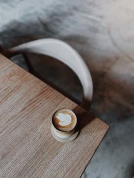 Minimalist coffee presentation with latte art in a cozy setting.