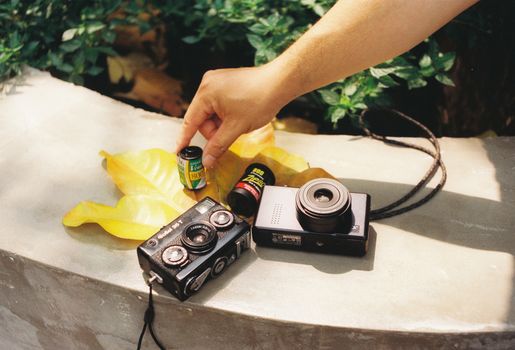 Photo of Two Analog Cameras on a Leaf