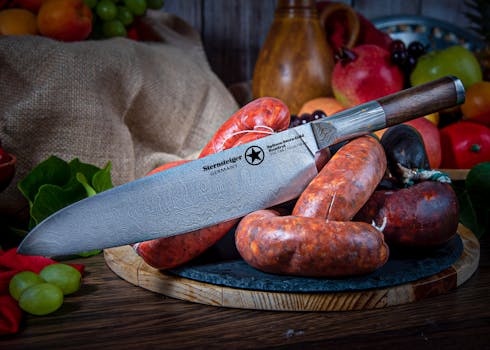 A high-quality German knife displayed with an assortment of sausages and fruits, showcasing fine details and craftsmanship.