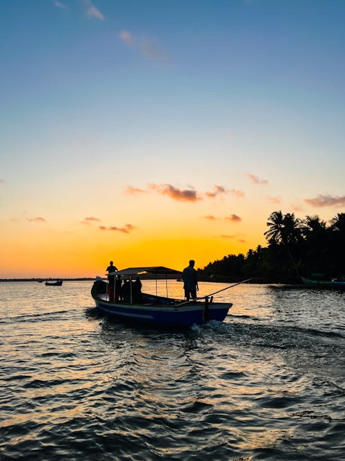 Fishing Boat on Sea Coast at Sunset