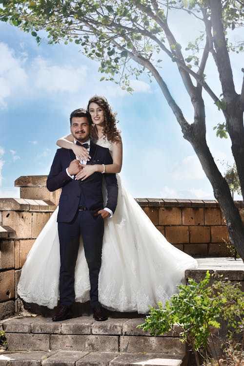 Free Woman Hugging Man Standing on Steps Stock Photo