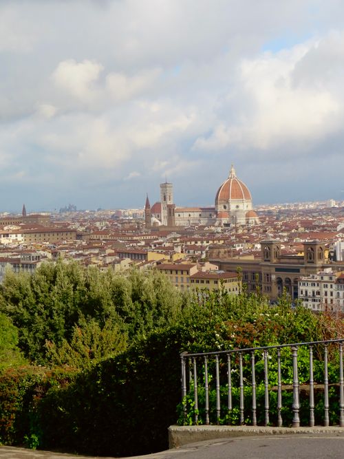 Free Panoramic vista of Florence featuring the famed Duomo under a cloudy sky. Stock Photo