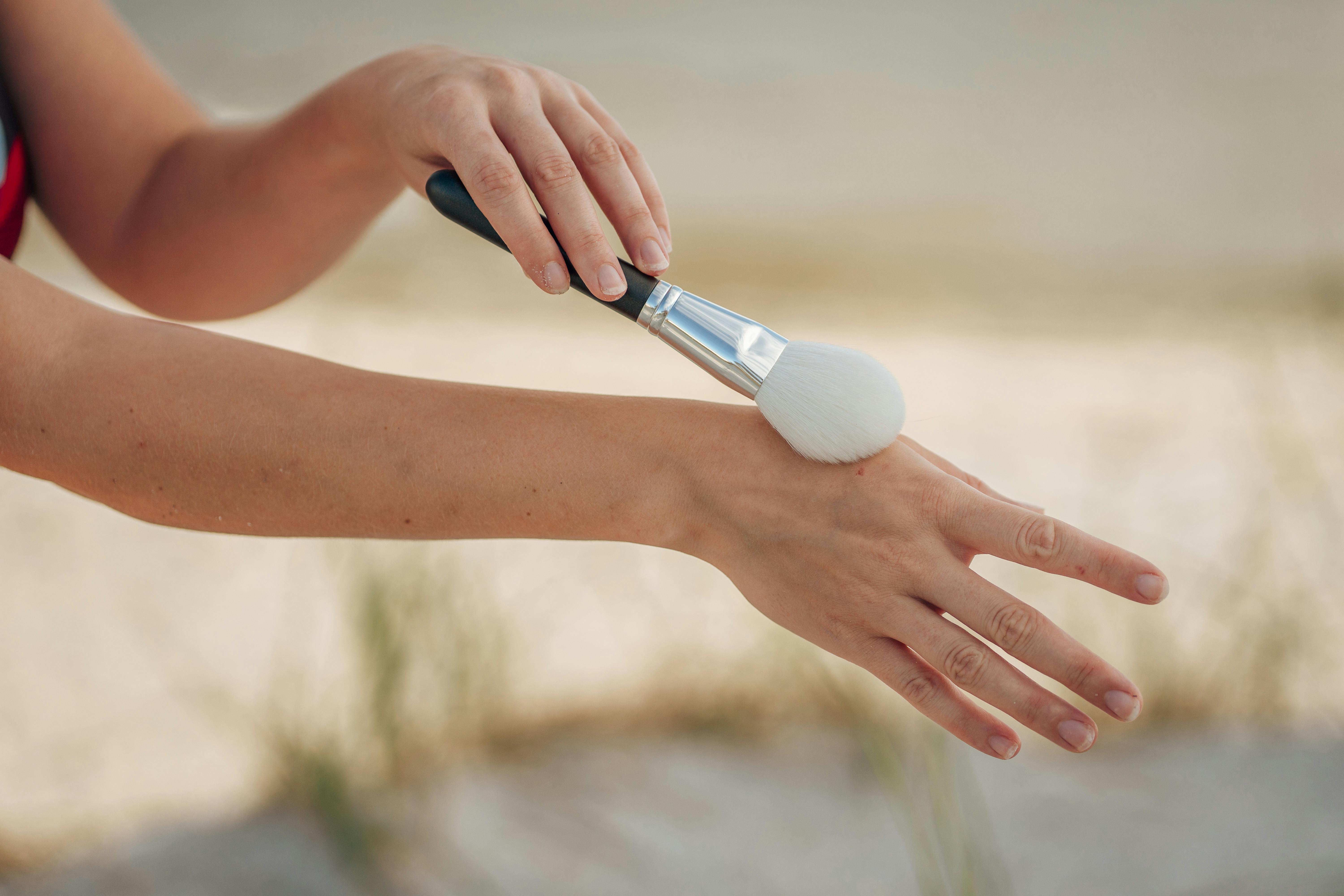 Closeup of a Cosmetician Applying a Cream on the Back for Acne Scars