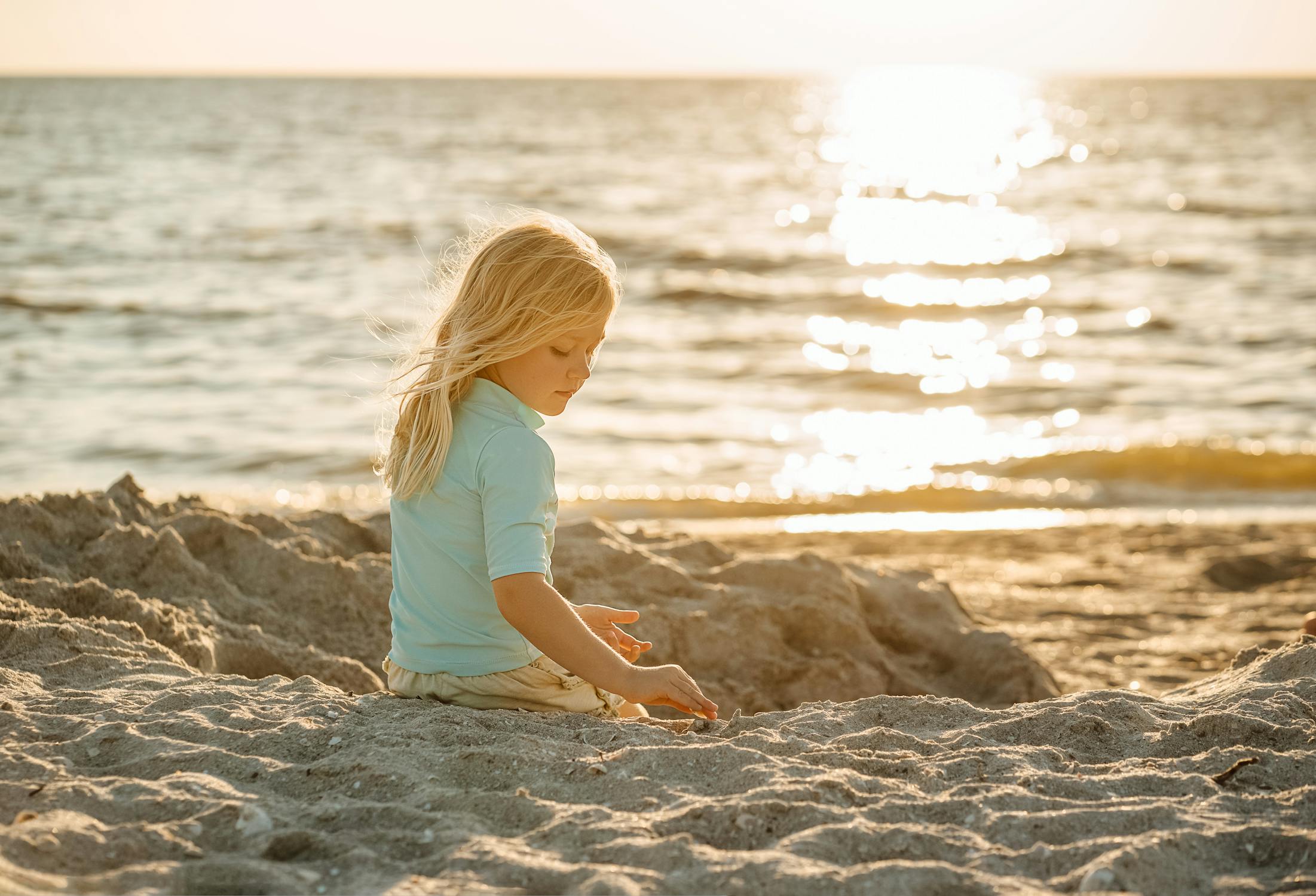 Summer Photo by Olya Harytovich from Pexels: https://www.pexels.com/photo/blond-girl-sitting-on-a-sandy-beach-and-sun-reflecting-in-the-sea-16401259/