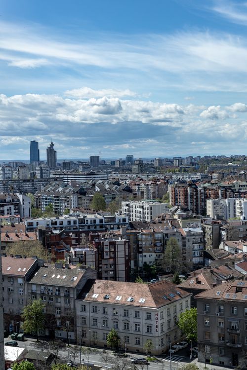 Free Discover the expansive skyline of Belgrade, Serbia, featuring a mix of modern and historic architecture under a bright blue sky. Stock Photo