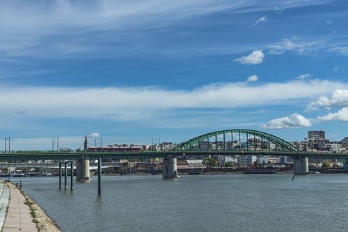 Free A picturesque view of the Old Sava Bridge spanning the river in Belgrade, Serbia, under a clear blue sky. Stock Photo