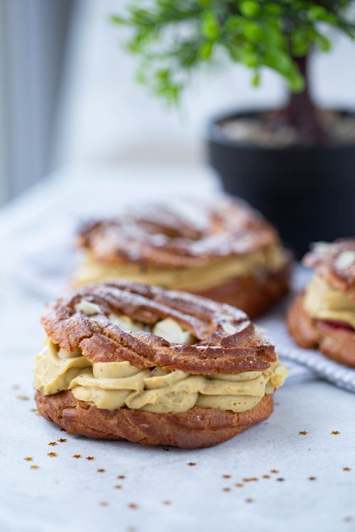 Free Tasty cream-filled pastries on a white table, perfect for a gourmet food shot. Stock Photo