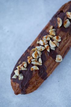 Delicious homemade eclair topped with chocolate and nuts for a sweet treat.