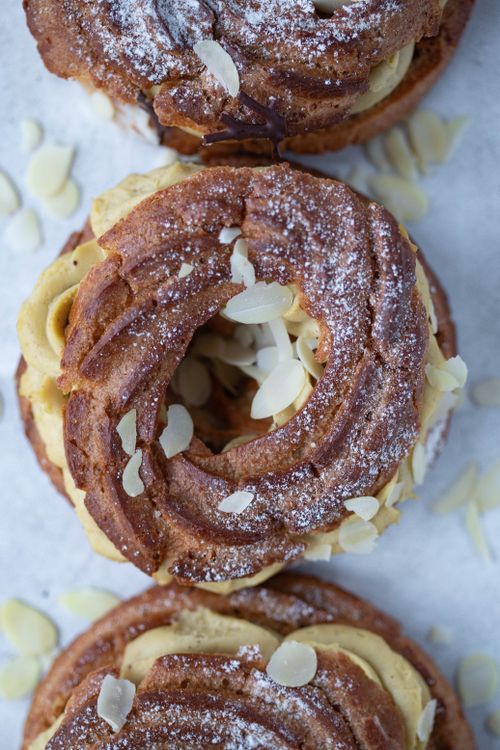 Free Close-up top view of Paris-Brest pastry with cream and almonds, dusted with sugar. Stock Photo