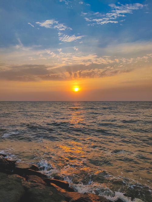 Stunning Beach Sunset with Vibrant Sky and Waves · Free Stock Photo