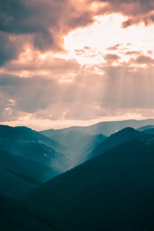 Free Sun Shining through the Clouds on Mountains  Stock Photo