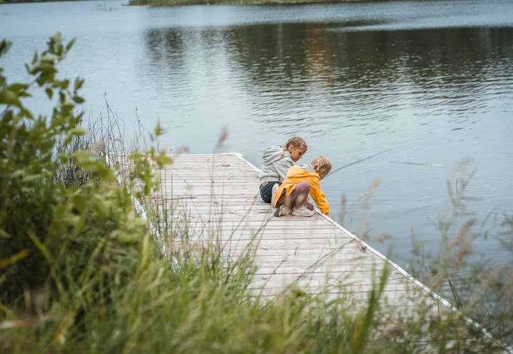 Two Girls Fishing On The Jetty 