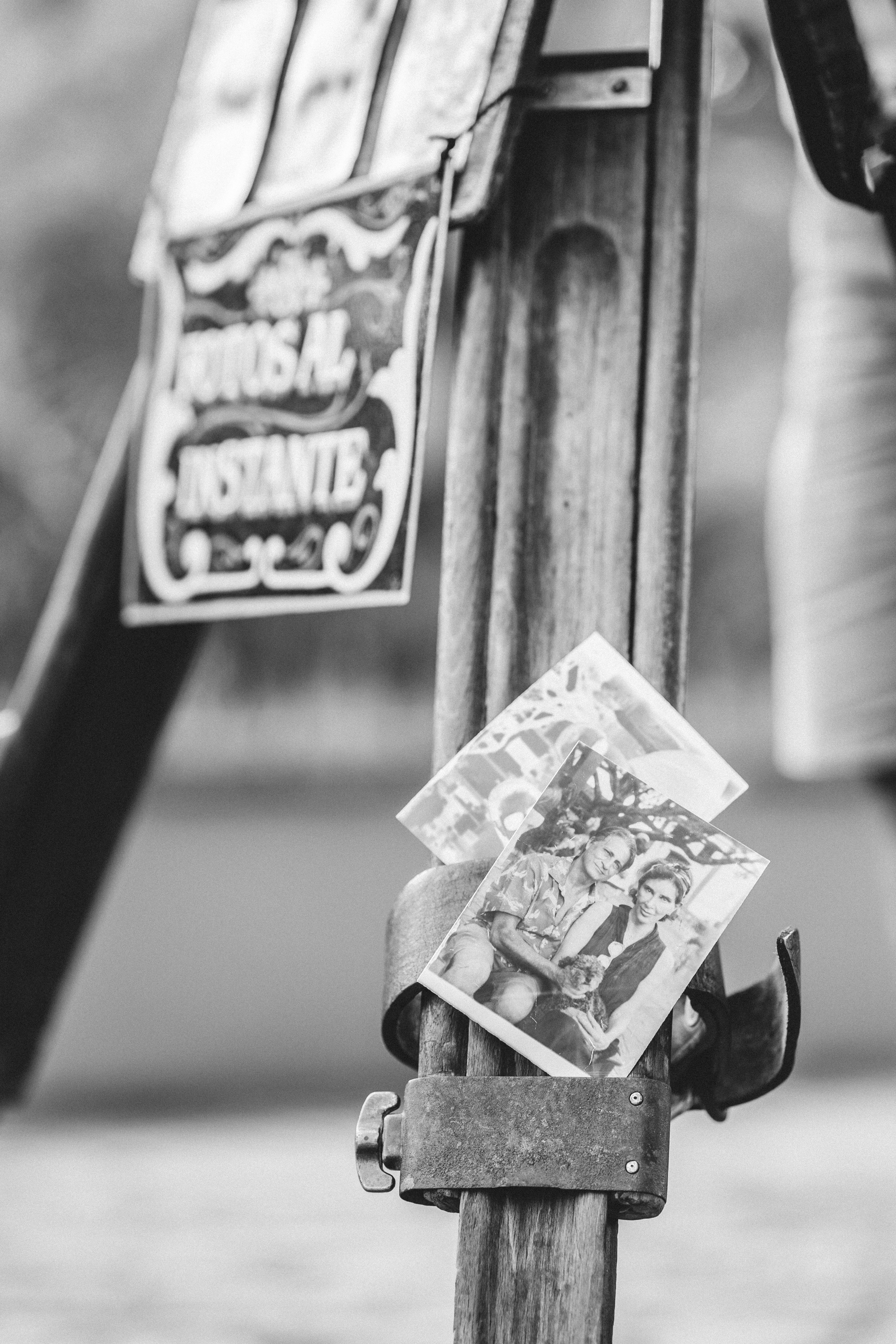 Black and white photo of vintage photographs on a street easel in Tiradentes, Brazil.