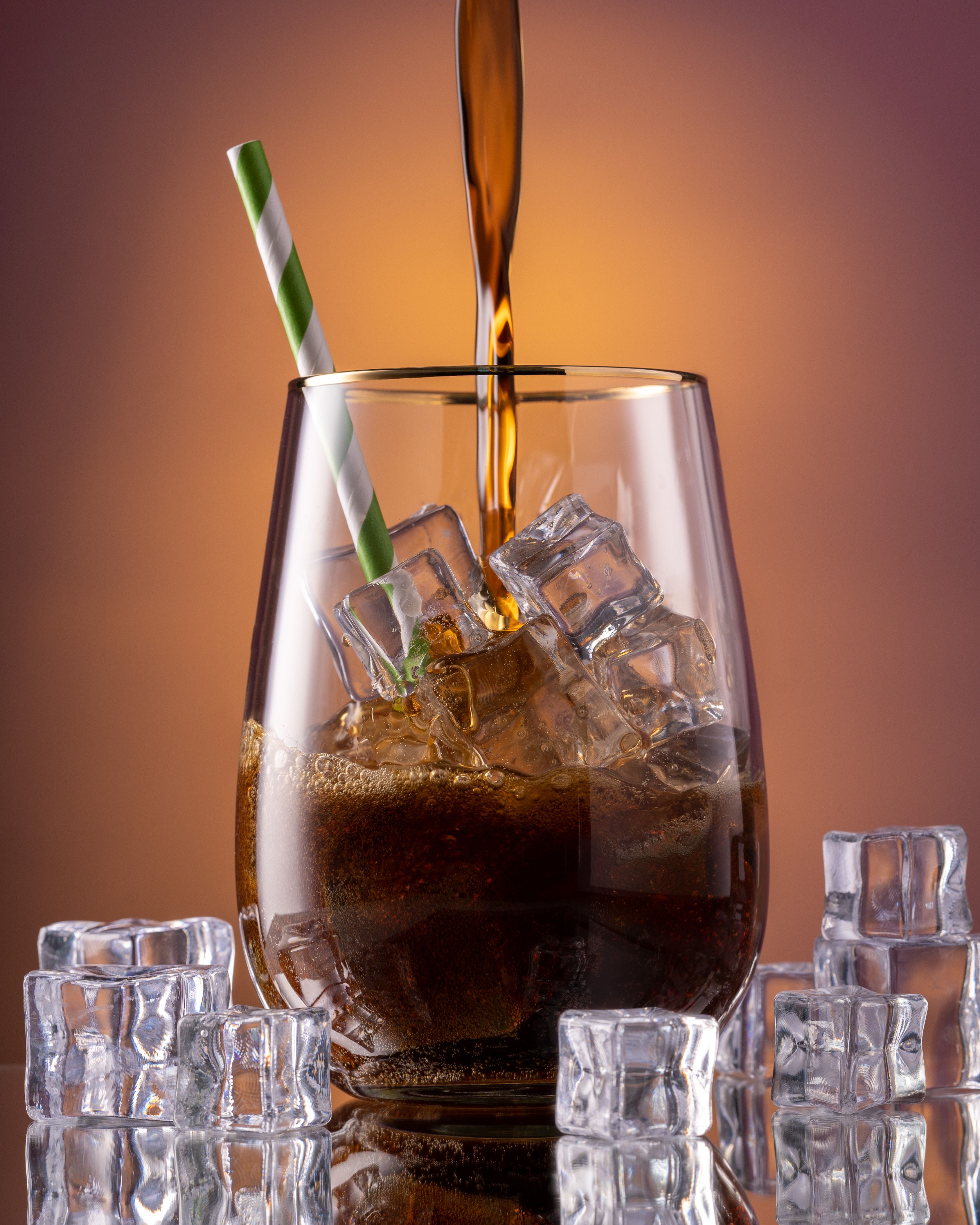 Close-up of Cola Being Poured into a Glass with Ice Cubes · Free Stock ...