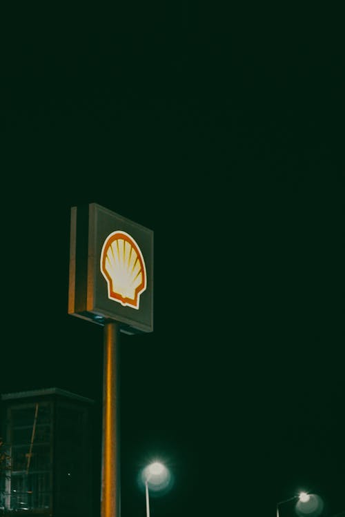 Illuminated Shell Logo Sign at Night 