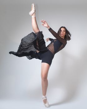 Ballerina in motion showcasing flexibility in elegant dance pose.