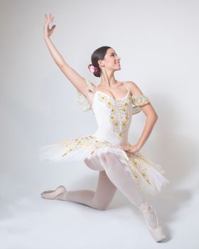 Elegant ballerina performing a graceful pose in a decorated tutu.