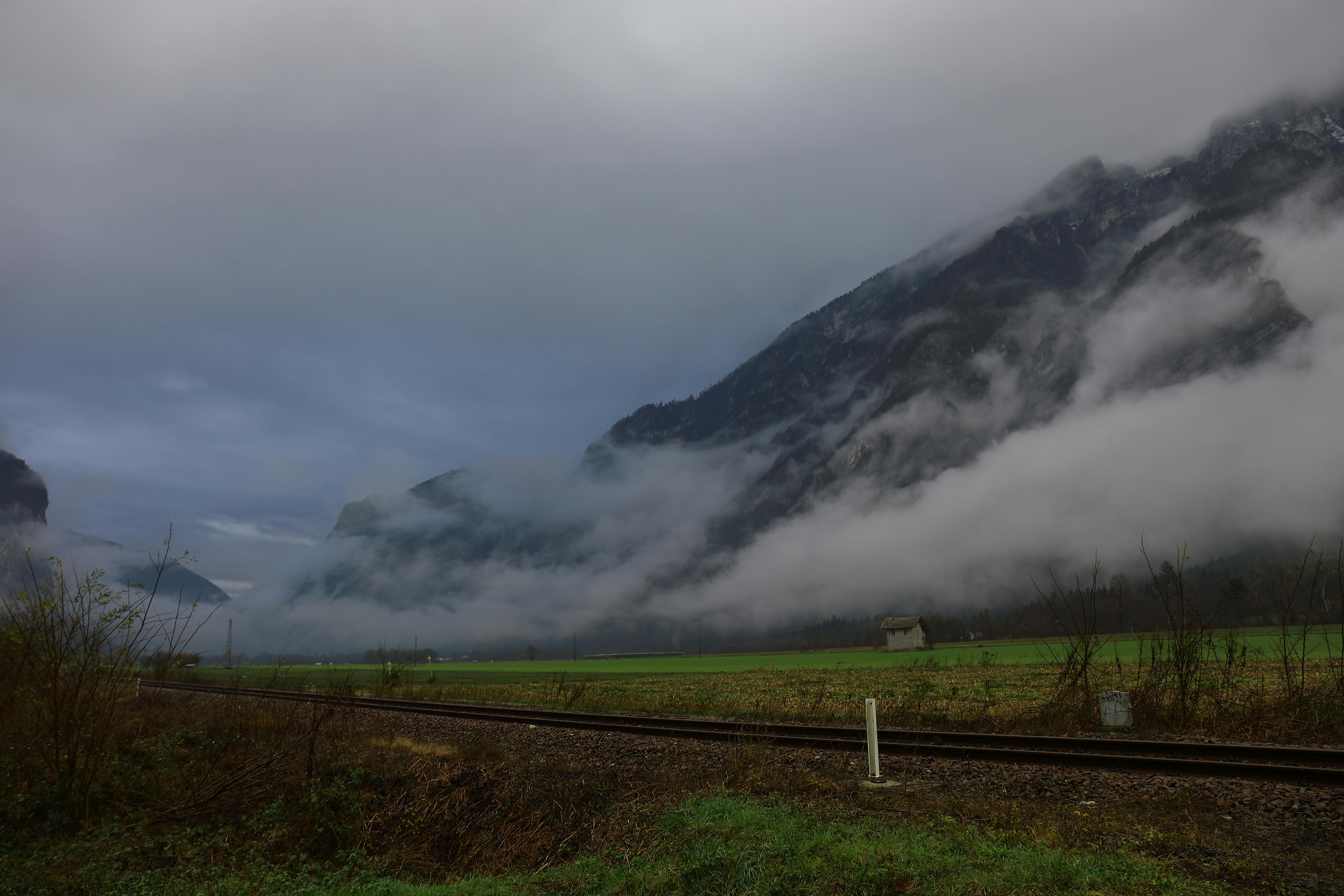 snow covered mountain with fogs