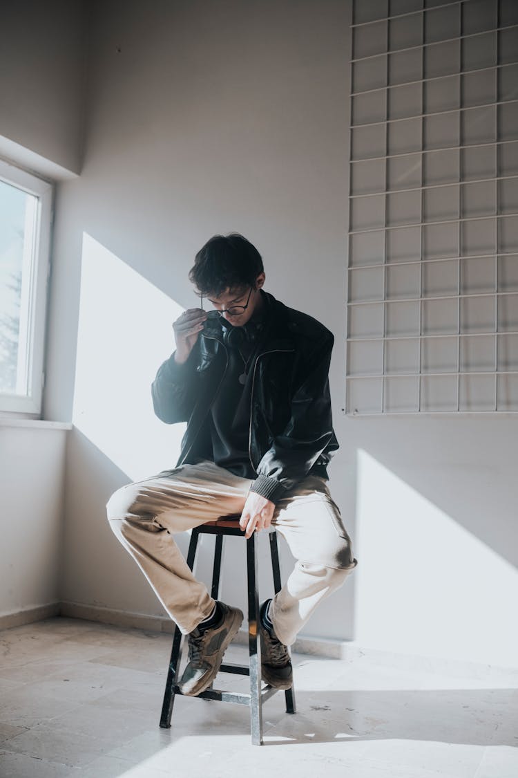 Man Sitting On A Chair In A Minimalist Interior