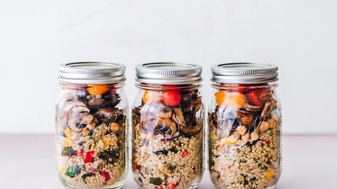 Colorful quinoa salad jar with roasted veggies, ideal for healthy meal prep.