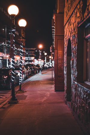 City street scene with parked cars. Photo by Erik Mclean on Pexels.