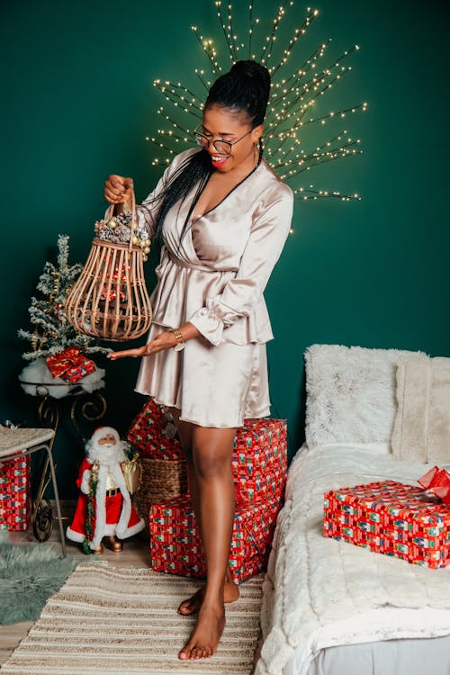 Woman Posing with Christmas Gifts behind
