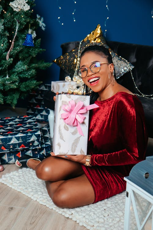 Woman Smiling and Posing with Christmas Gifts