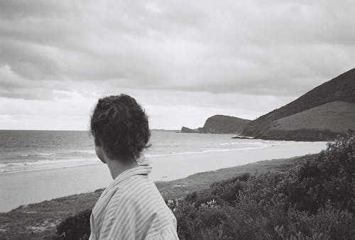 Overcast over Woman on Sea Coast in Black and White