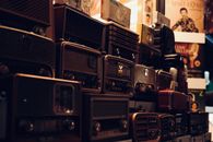 A nostalgic collection of vintage radios captured in warm ambient lighting.