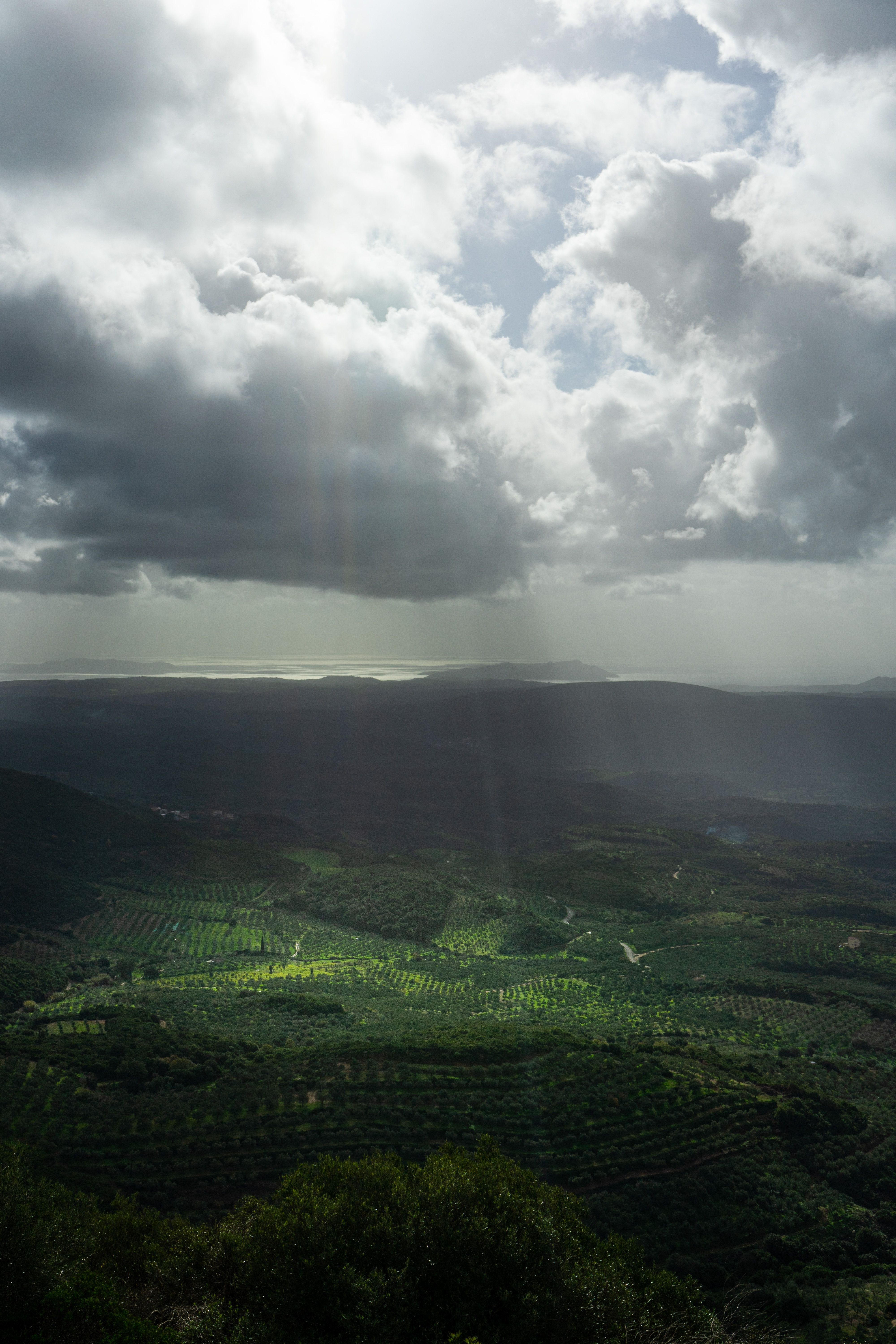 Sunbeams behind Clouds over Green Plains · Free Stock Photo