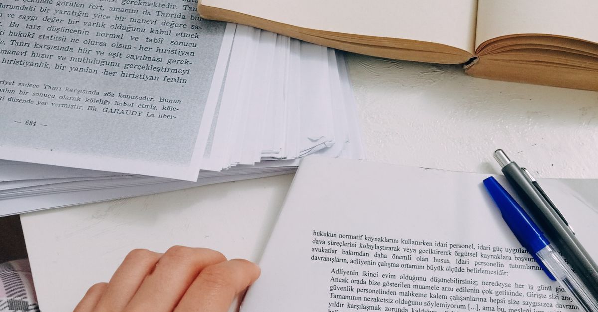 Paper And Notes Hands on Papers and Notes near Book · Free Stock Photo