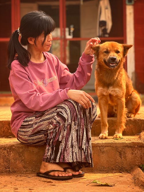Woman Sitting with Dog on Stairs