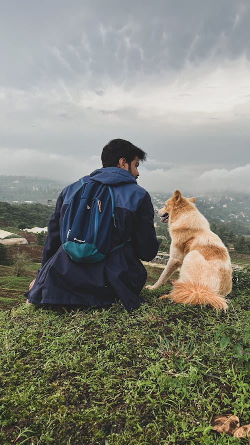 Backpacker with Dog in Mountains