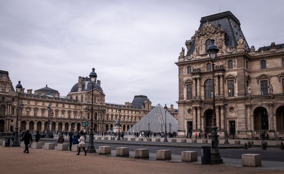 The iconic Louvre Museum with its modern glass pyramid in Paris, France.