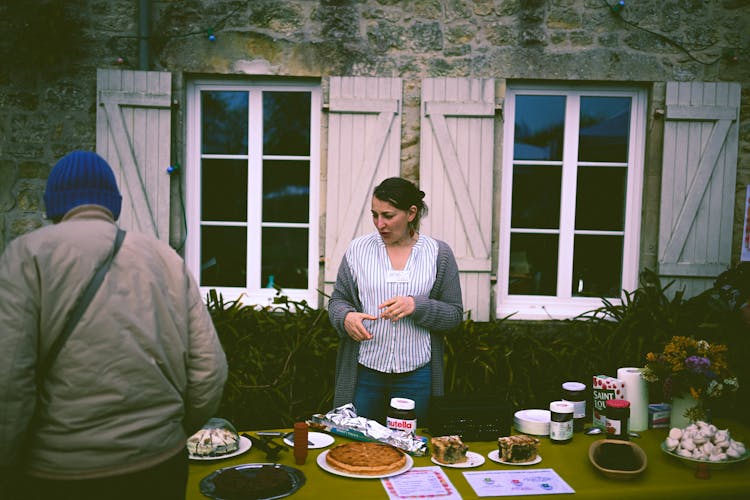 A Woman Selling Food At The Market