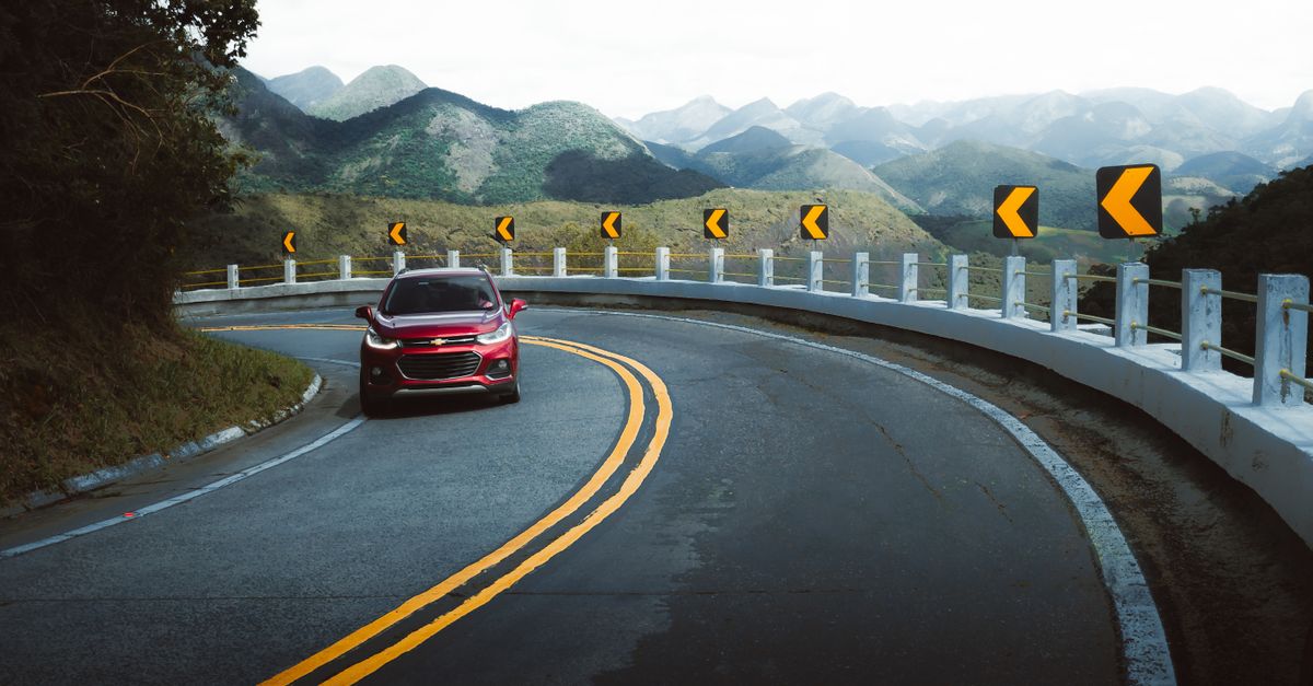 A Red Car on a Road · Free Stock Photo