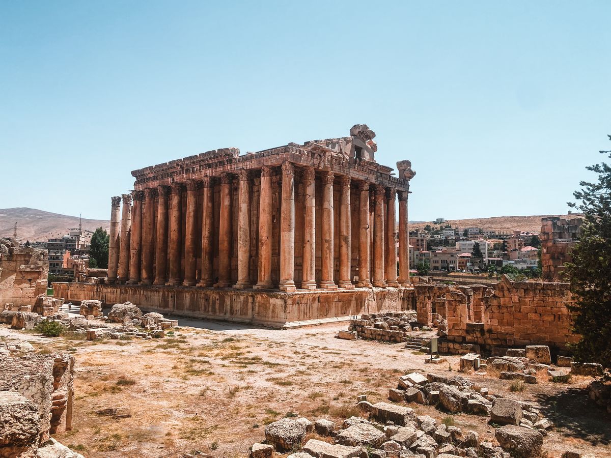 Six towering Roman columns of the Temple of Bacchus at Baalbek against a clear sky