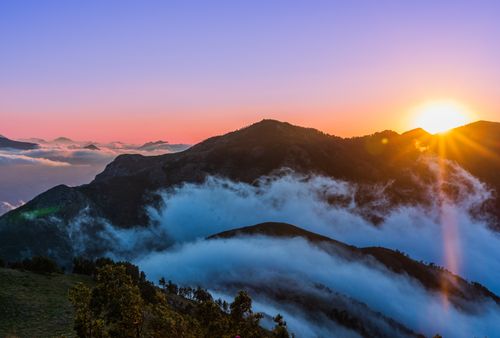 Free Stunning sunrise over mist-covered mountains in Mila Province with vibrant colors. Stock Photo