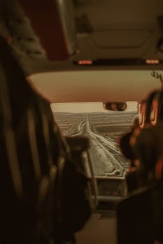 View of a long road from the interior of a bus, capturing a sense of travel and adventure.