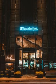 Capture of The Socialist entrance in Copenhagen, bathed in neon light at night.