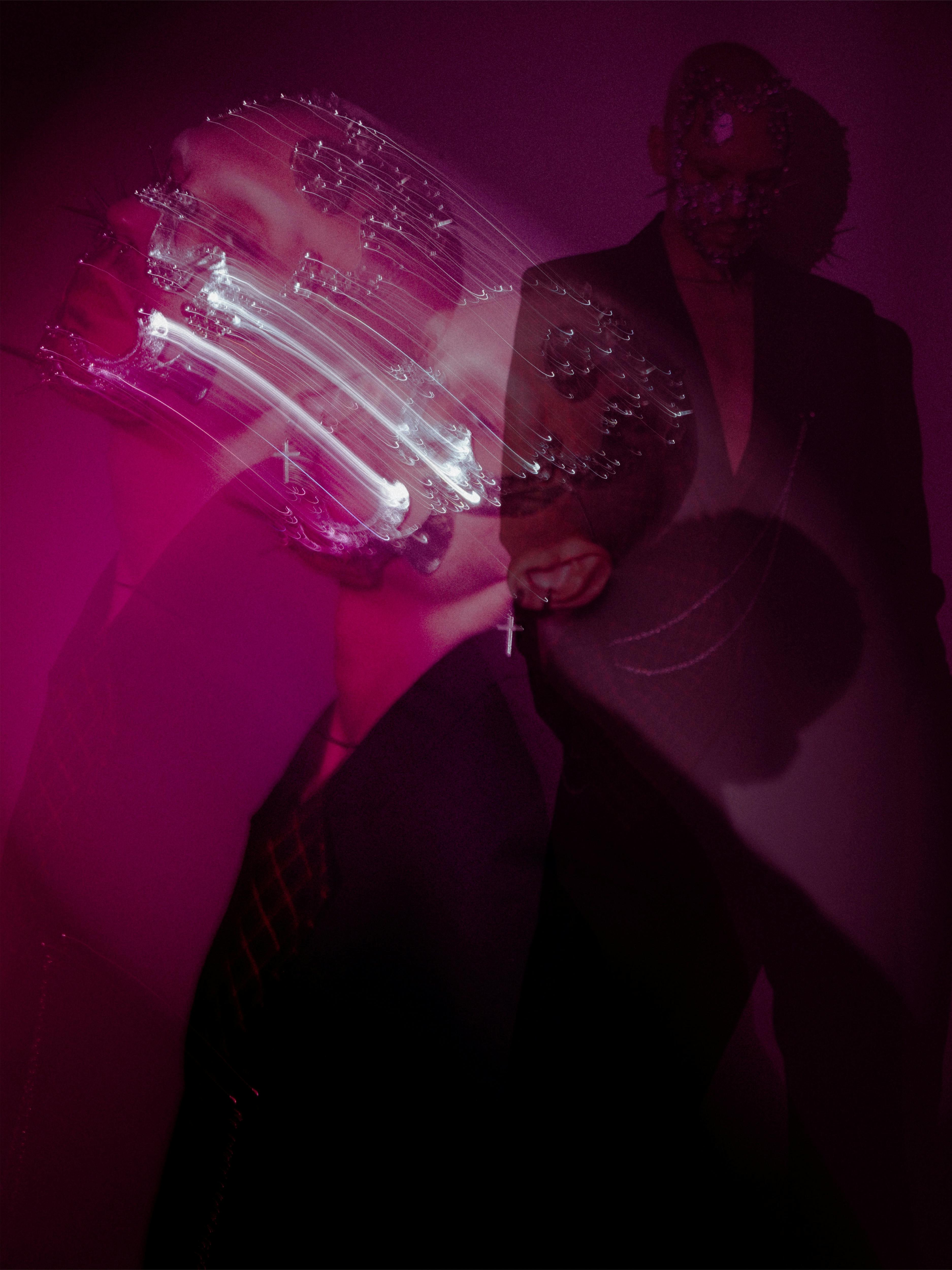 Surreal art portrait combining double exposure and mask elements in purple tones.