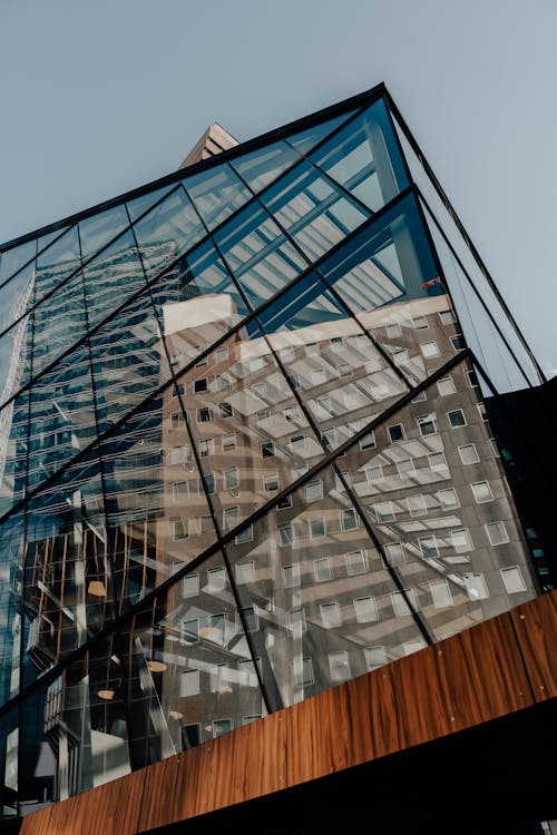 Low Angle Shot of Reflection of a Building in a Modern Glass Facade 