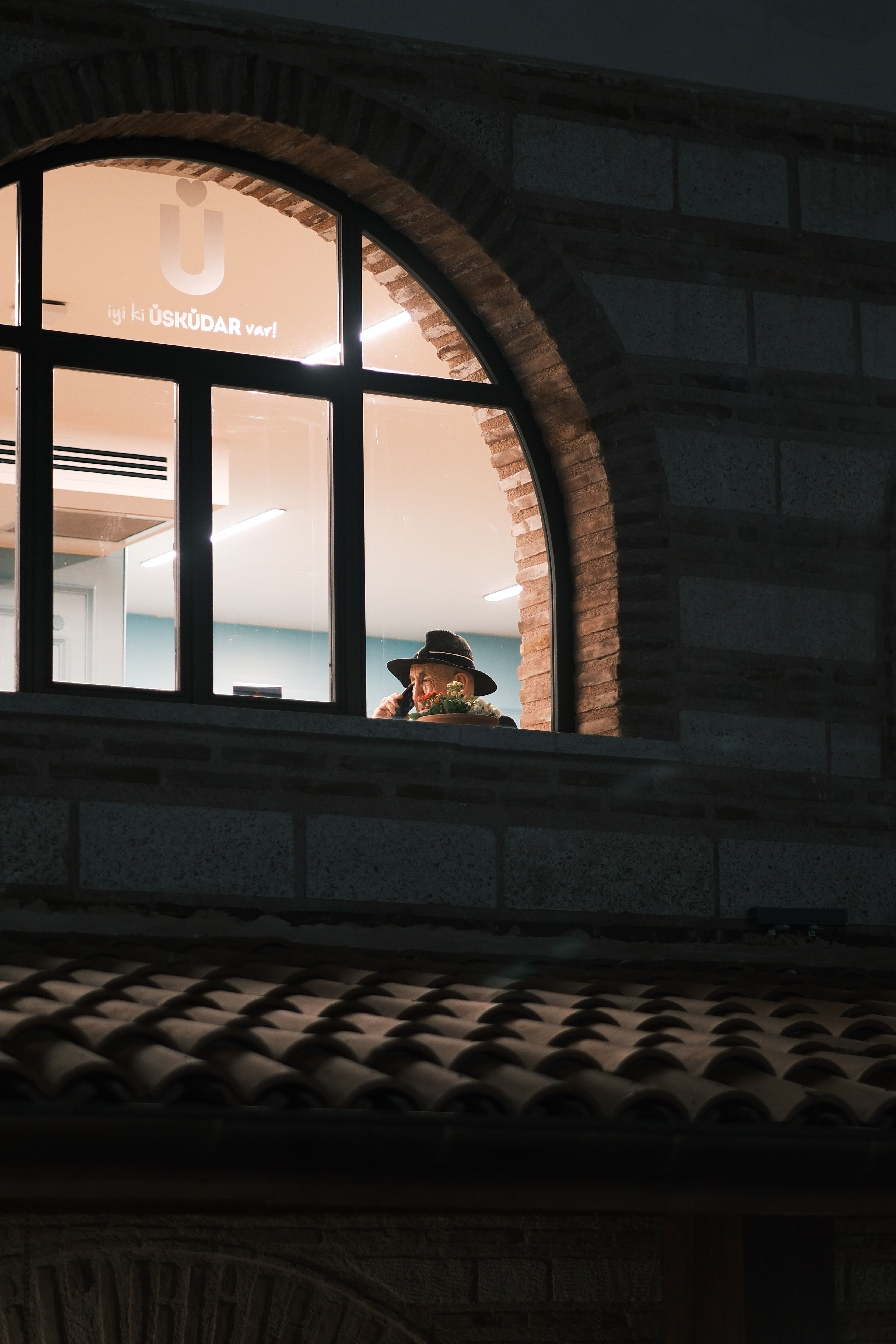 Person in Hat Sitting behind Windows · Free Stock Photo